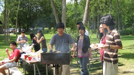 Lab members grilling food at Green Lakes State Park in 2009